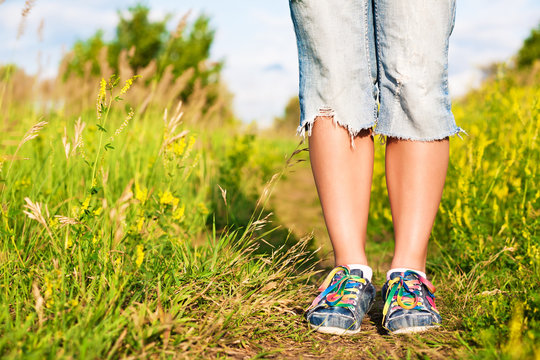 female feet on the path in the park.