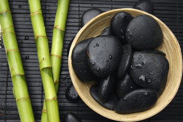 bowl of zen stones and bamboo grove on bamboo stick straw mat