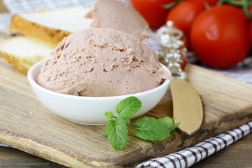 Homemade  liver appetizer pate  on a wooden board