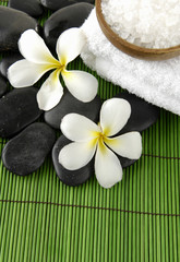 Naklejka na ściany i meble frangipani flower and zen stones with salt in bowl and towel