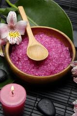 herbal salt in bowl and green leaf and orchid with stones