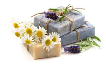 Obraz na płótnie Canvas soap bars with fresh lavender and chamomile flowers