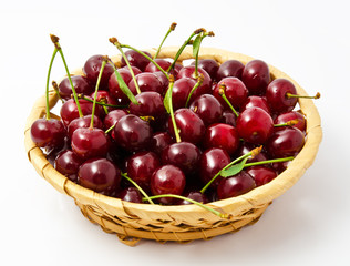 Basket with ripe wet cherry isolated