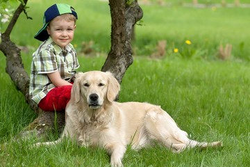 A little boy and dog on garden