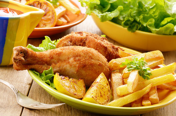 Fried drumsticks with french fries