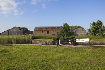 Fototapeta na wymiar canal lock and barns