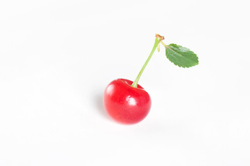 cherry with green leaf on white background
