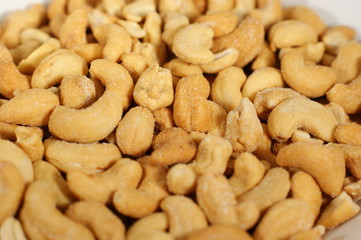 Delicious cashew nuts isolated on a white plate - Close up