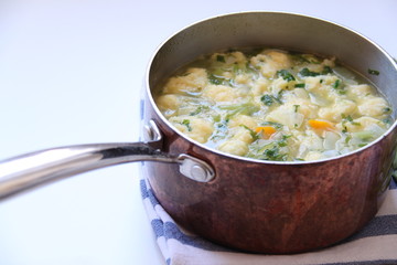 Vegetable soup in a copper pan