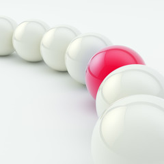 Row of white ones and red glossy spheres