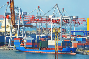 Container stack and ship under crane bridge