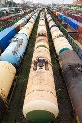 containers and cars at the railroad station