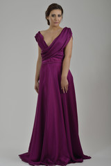 elegant woman in fashionable dress posing in the studio