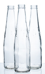 Three empty bottles on a white background.