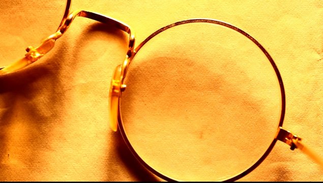 Reading glasses on pape