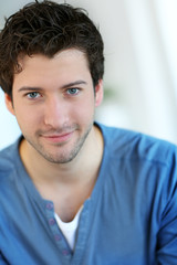 Portrait of cheerful young guy with blue eyes