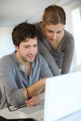 Fototapeta premium Young people studying from home with laptop computer