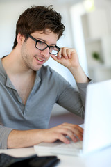 Young man studying from home