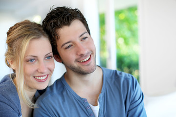 Obraz na płótnie Canvas Closeup of cheerful young couple wearing blue