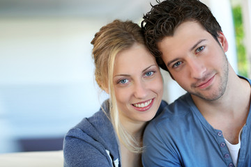 Closeup of cheerful young couple wearing blue