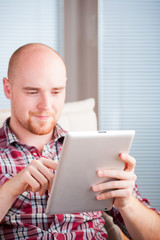 Focused man working and playing with tablet computer (lots of co