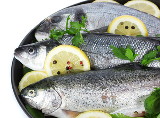 Fresh fishes with lemon, parsley and pepper