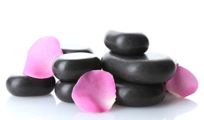 Spa stones and rose petals isolated on white