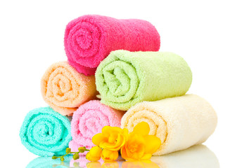 Obraz na płótnie Canvas colorful towels and flowers isolated on white