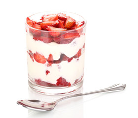 Glass of ripe strawberries with cream isolated on white