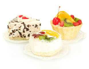sweet cakes with fruits and chocolate isolated on white