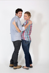 Young couple showing thumbs up on white background