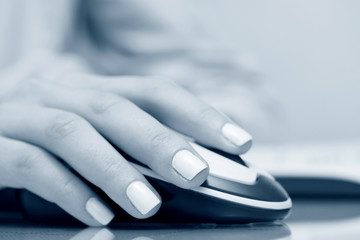 Female hand holding computer mouse