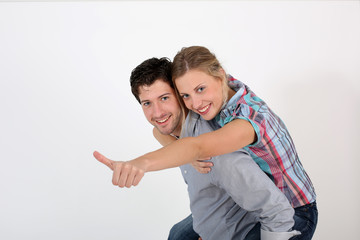 Young man carrying girlfriend on his back