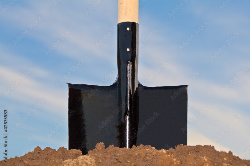 Wall mural shovel in the heap of ground