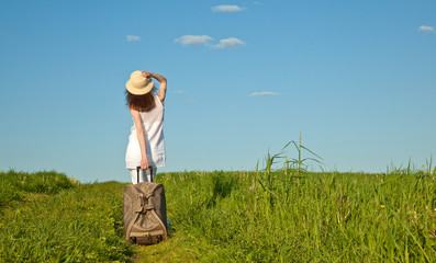 Beautiful young woman walking with a suitcase