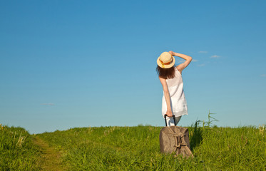 Beautiful young woman travelling with a suitcase