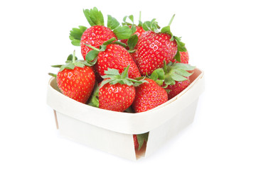 Red Strawberries in a basket. Closeup. On a white background.