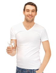 man in white shirt with glass of water