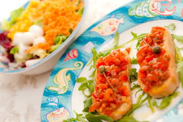 Mix Salad with tomato bruschetta on background.