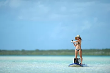 Selbstklebende Fototapeten Fishing and paddleboarding in tropical destination © ftlaudgirl