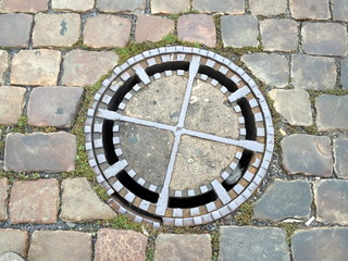 rock ground with an iron manhole cover