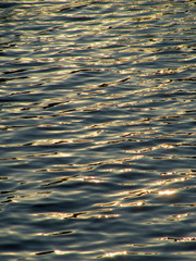 Dark blue wavy surface of the sea at sunset
