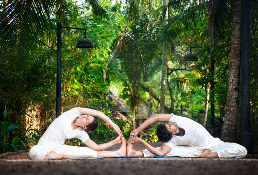 Couple yoga in the garden