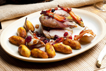 baked pheasant with bacon, pear, raisins on brandy