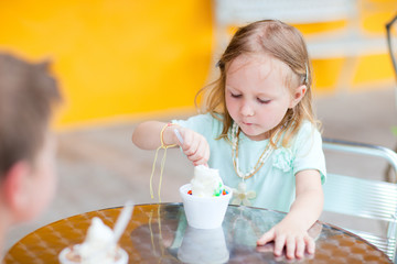 Adorable girl eating ice cream
