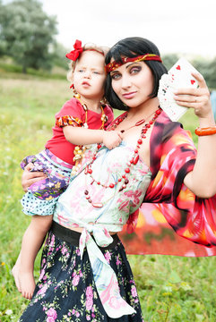 beautiful gypsy girl in a red dress with the baby