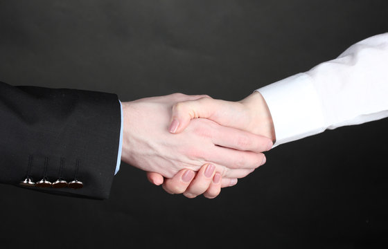 Business handshake on gray background