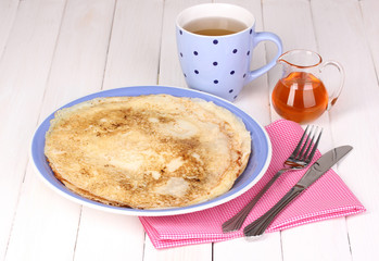 Stack of tasty pancakes on wooden background