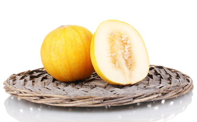 Ripe melon on wicker mat isolated on white