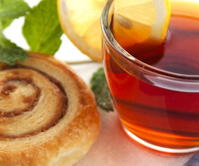 Cup of tea with cinnamon Danish bun